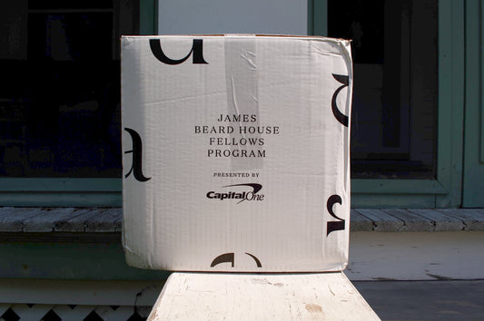 a cardboard box sitting on top of a wooden bench