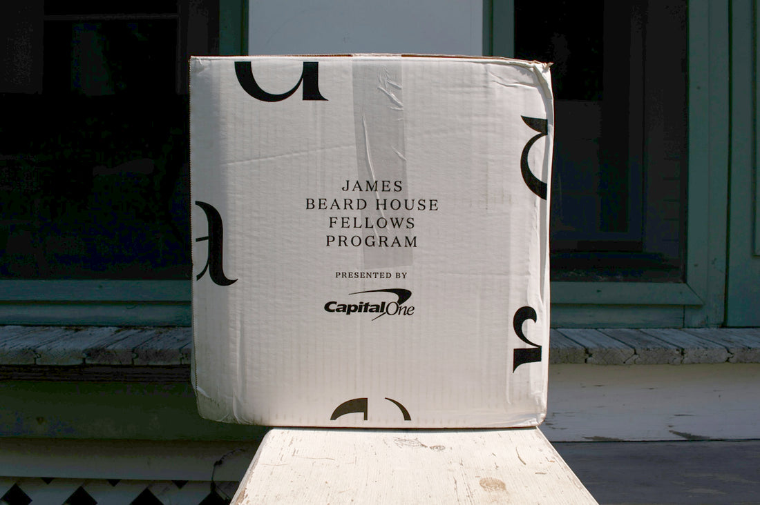 a cardboard box sitting on top of a wooden bench