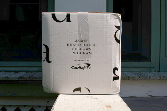 a cardboard box sitting on top of a wooden bench