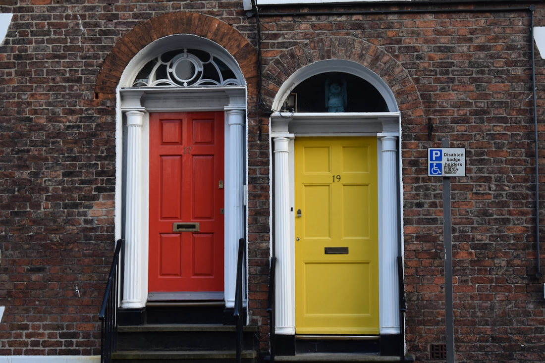 a couple of red and yellow doors sitting next to each other