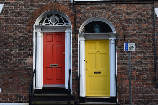 a couple of red and yellow doors sitting next to each other