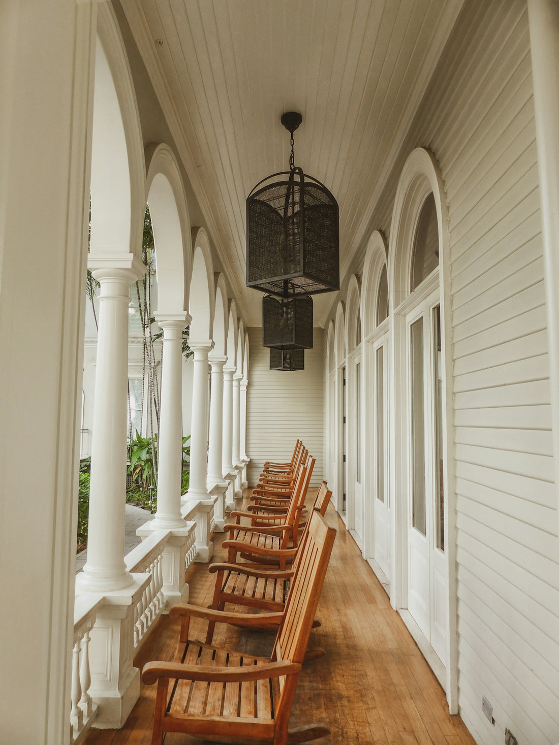 a row of wooden benches sitting on top of a wooden floor
