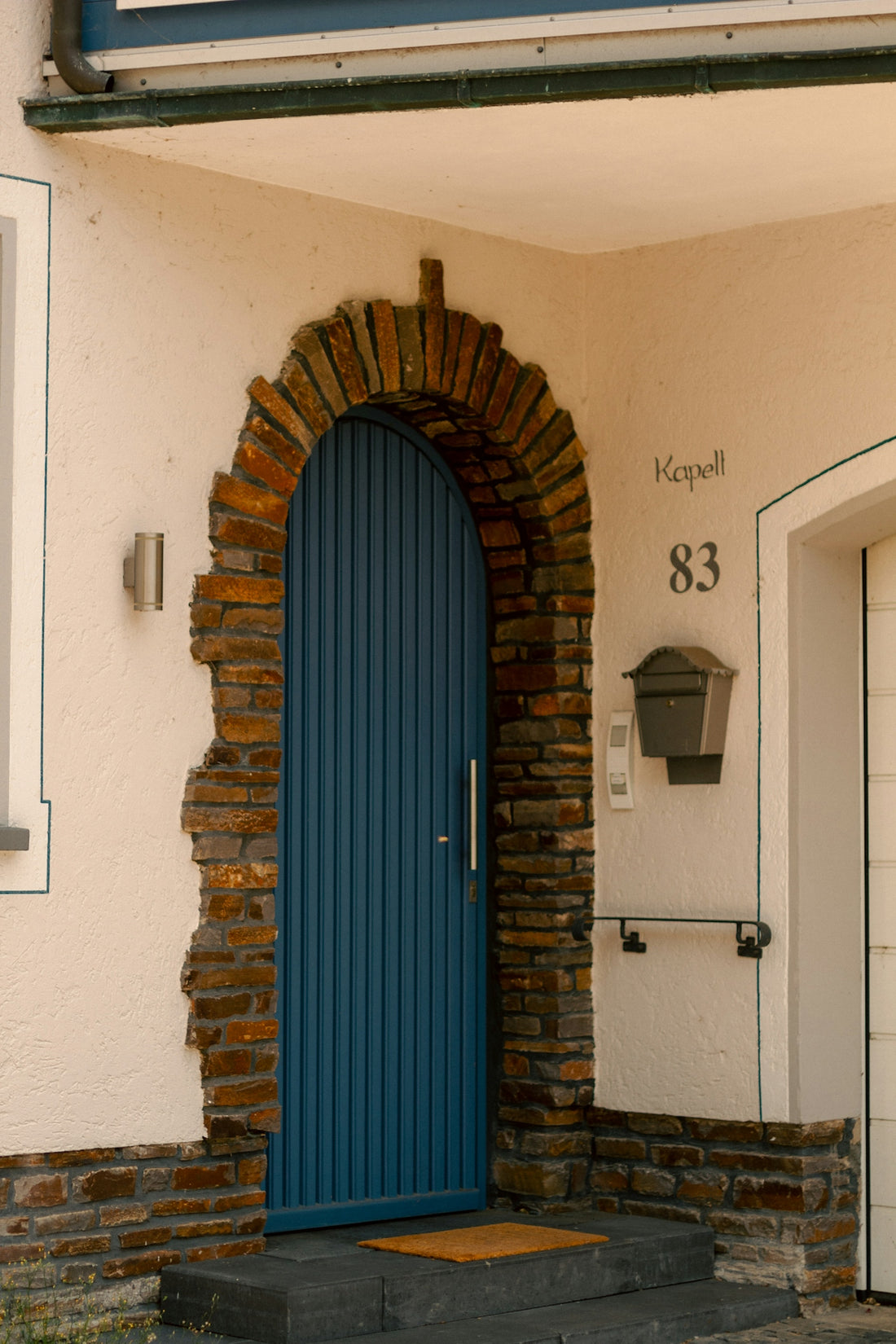 a blue door in front of a brick building