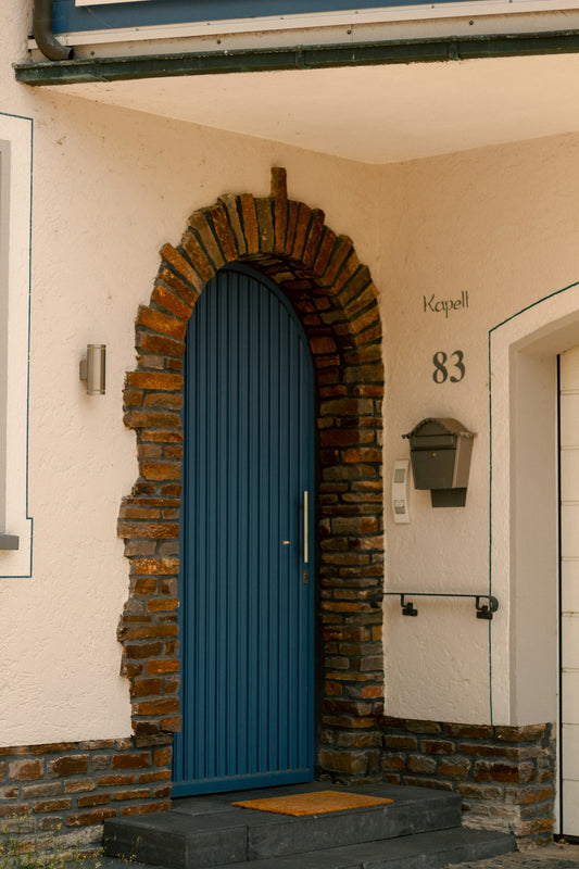 a blue door in front of a brick building