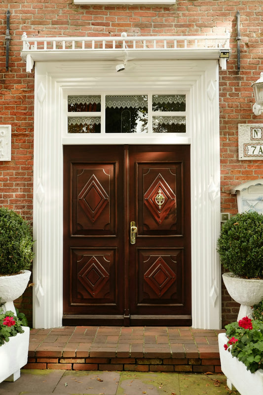 A brick building with two large wooden doors