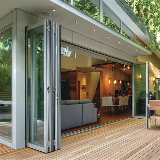 Modern home with folding glass doors opening to deck.