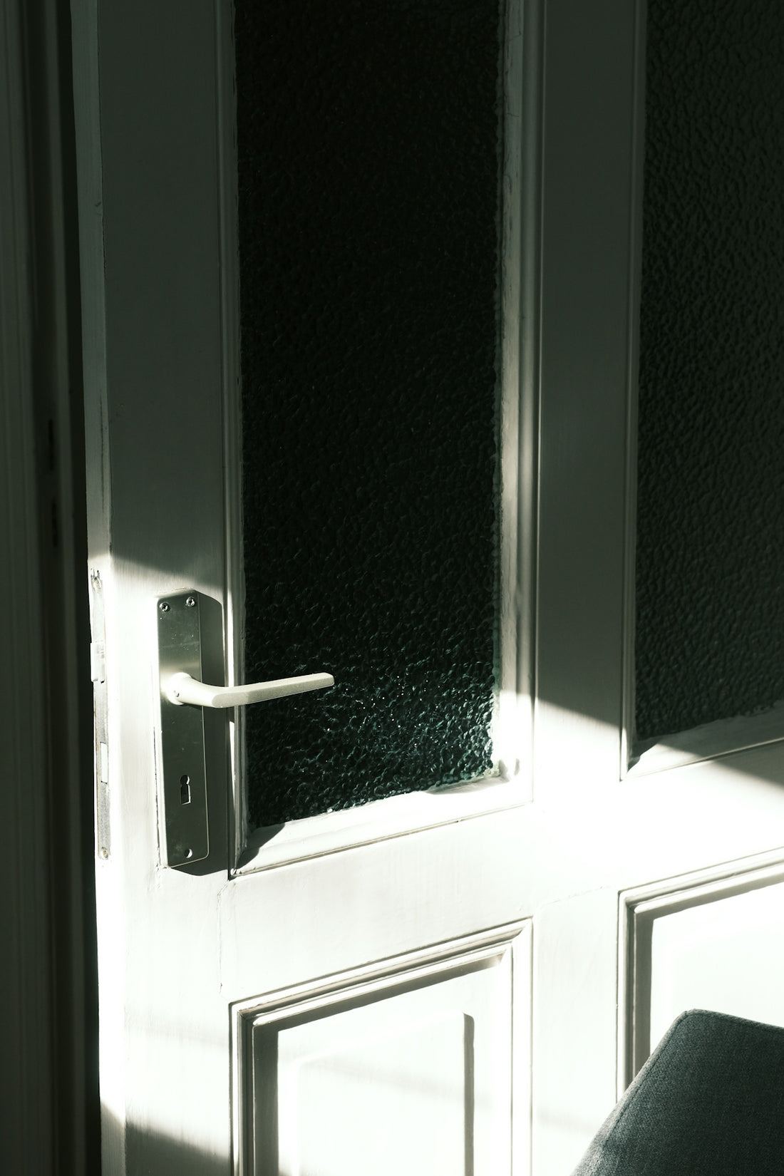 Sunlight streams through a glass-paneled door.