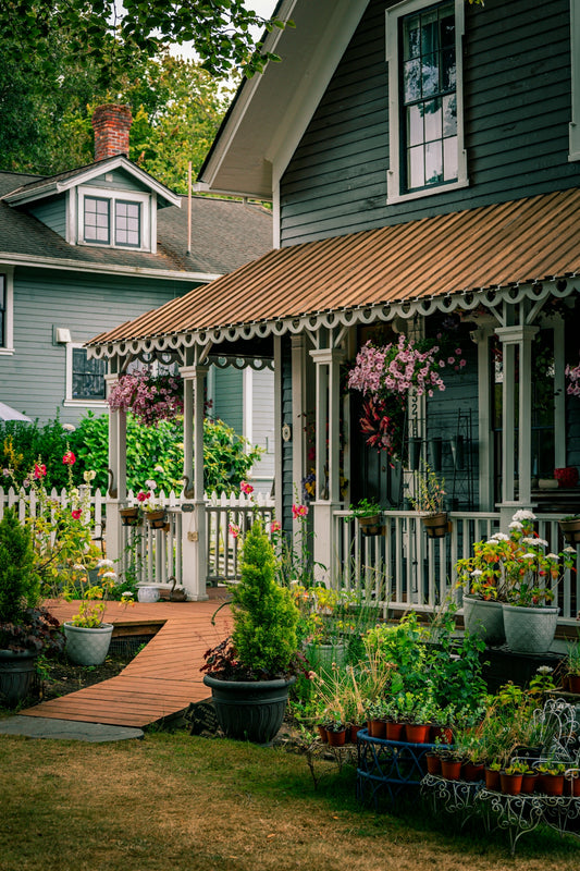 Charming house with a white picket fence and flowers.