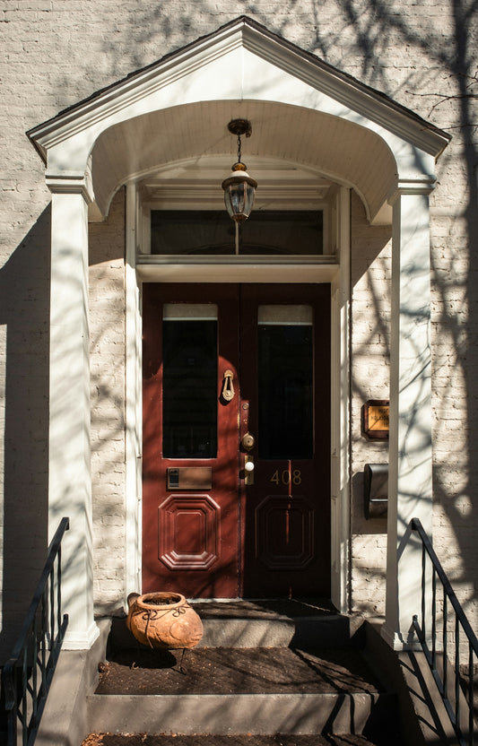 A red front door with a hanging lantern above.