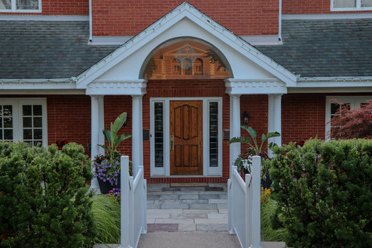 Elegant front entrance of a red brick house.