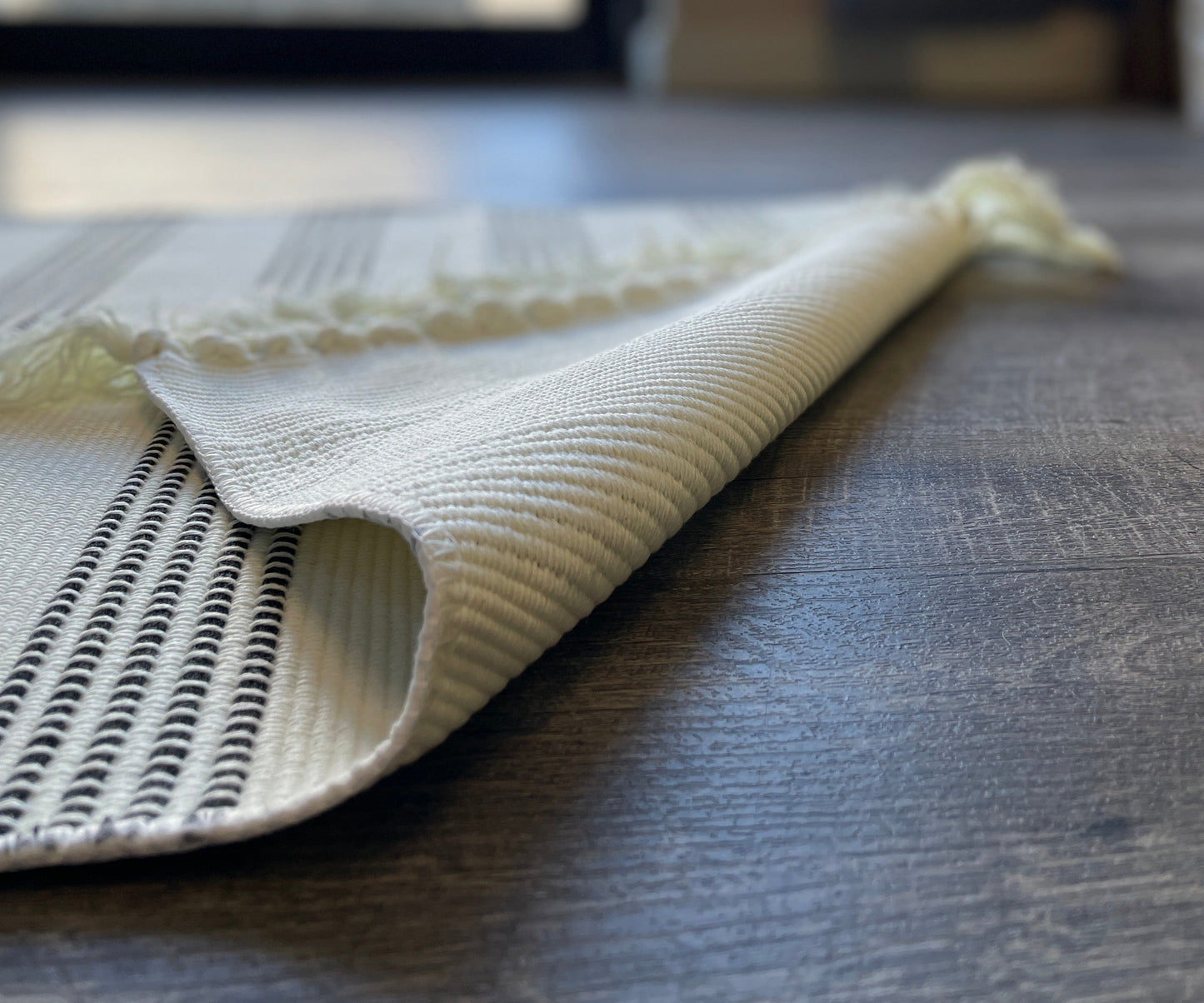 Black and White Striped Accent Rug With Fringe